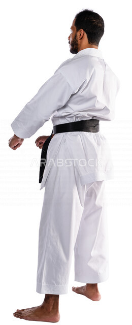 Portrait of a Saudi Arabian Gulf man practicing Japanese karate, white karate uniform with black belt, training in special combat movements, Japanese martial arts, martial arts, physical strength, application of kata movements, white background, full-leng