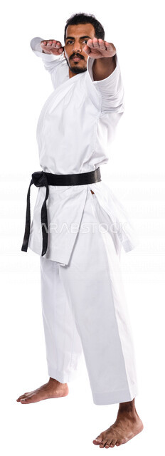 Portrait of a Saudi Arabian Gulf man practicing Japanese karate, white karate uniform with black belt, training in special combat movements, Japanese martial arts, martial arts, physical strength, application of kata movements, white background, full-leng
