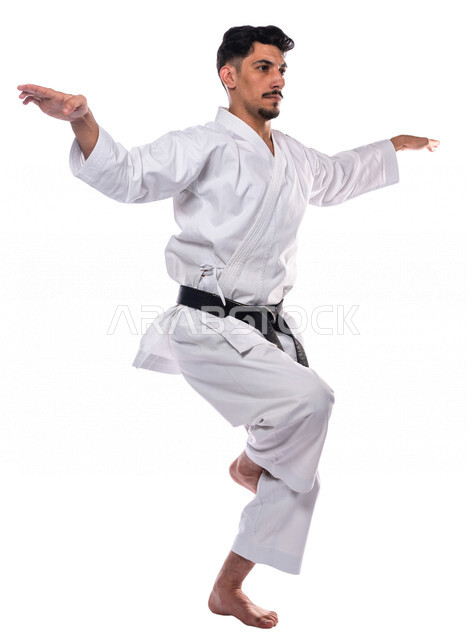 Portrait of a Saudi Arabian Gulf man practicing Japanese karate, white karate uniform with black belt, training in special combat movements, Japanese martial arts, martial arts, physical strength, application of kata movements, white background, full-leng