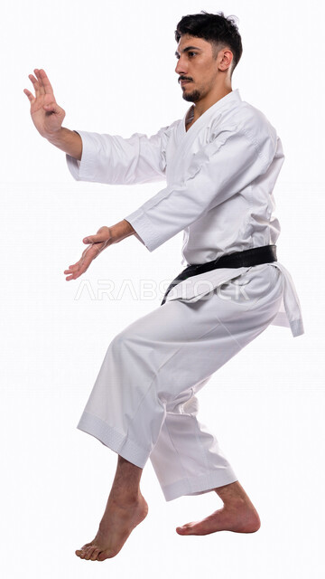 Portrait of a Saudi Arabian Gulf man practicing Japanese karate, white karate uniform with black belt, training in special combat movements, Japanese martial arts, martial arts, physical strength, application of kata movements, white background, full-leng