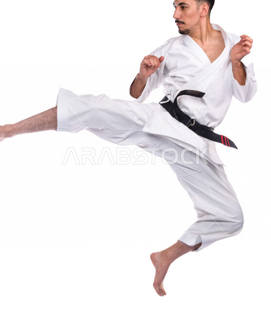 Portrait of a Saudi Arabian Gulf man practicing Japanese karate, white karate uniform with black belt, training in special combat movements, Japanese martial arts, martial arts, physical strength, application of kata movements, white background, full-leng