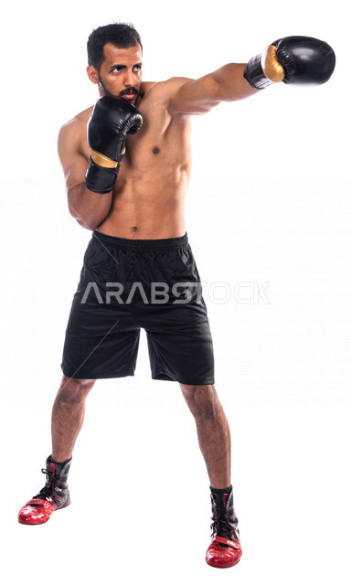 Portrait of a Saudi Arabian Gulf man wearing boxing gloves, practicing self-defense, training in combat movements, boxing and wrestling, health and fitness, Saudi boxing team, full-length picture, full body