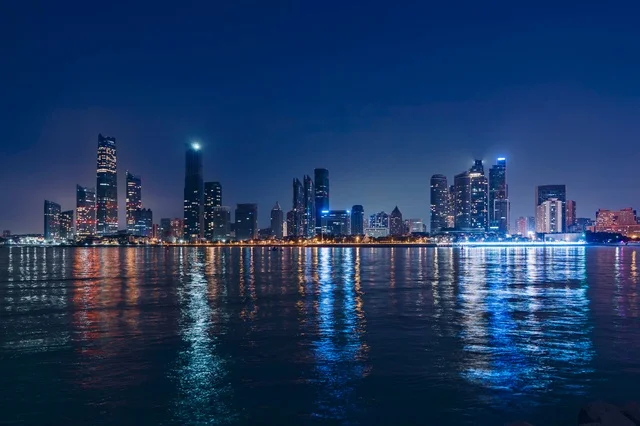 Abu Dhabi Skyline Night Reflection in Arabian Gulf
