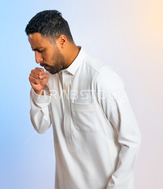 بورتريه لرجل عربي سعودي خليجي يقوم بالسعال , إيماءات وجه ويدين تدل على التعب والألم ، الاصابة بنزلة برد ،  التهاب الحلق ، الاصابة بفايروس كورونا 