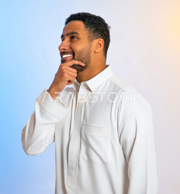 Portrait of a smiling Saudi Arab Gulf man with hand gestures indicating listening, listening, thinking and meditation, positive thoughts