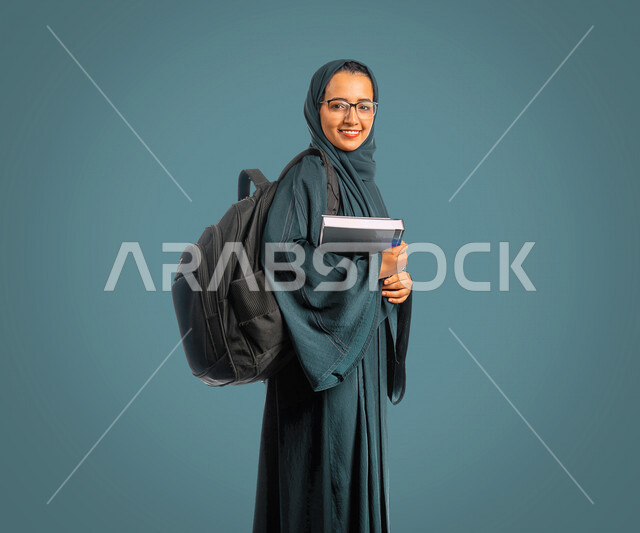 Portrait of a Saudi Arabian Gulf university student holding university books, preparing for the new academic year, academic education in the Kingdom of Saudi Arabia, stage of study, teaching and learning