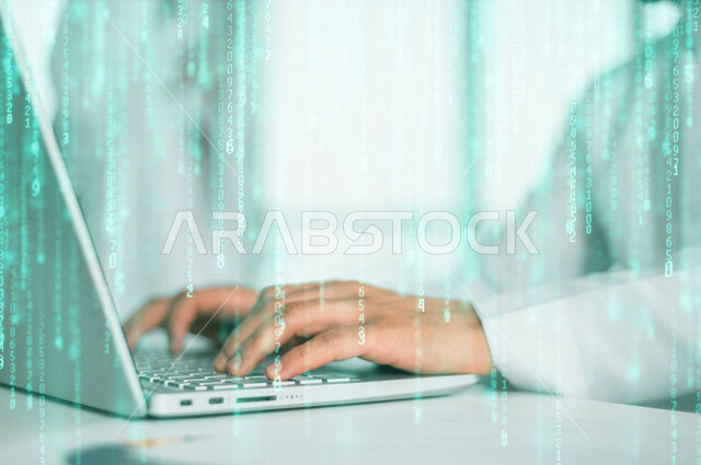 صورة مقربة ليد رجل عربي خليجي سعودي يستخدم الحاسوب المحمول ، وظيفة مطور ويب، استخدام لغات البرمجة، تطوير وبناء المواقع والتطبيقات الالكترونية، التعليم اونلاين ، العمل عن بعد ، خلفية للبيانات الرقمية بتقنية الهولوجرام