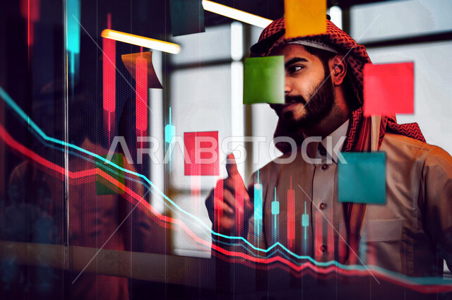 رجل عربي خليجي سعودي يقوم بقراءة الملاحظات والمهام على الورق ، انجاز مهام العمل ، تحقيق الاهداف المالية والاقتصادي للشركة ، نمو الأعمال والتخطيط ، خلفية للاحصاءات والرسم البياني ثلاثي الابعاد