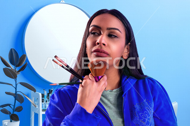 A Saudi Arabian Gulf woman holding a set of make-up brushes, one of the cosmetics on the face, a colorful background for an expert woman in cosmetics, marketing of cosmetic products, a store selling cosmetics, the concept of taking care of beauty and skin