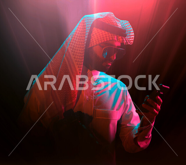 رجل عربي سعودي خليجي يستخدم الهاتف المحمول, التسوق الإلكتروني، دردشه ومحادثات، التجاره الإلكترونيه، متابعة الأسهم، إدارة الأعمال, إجتماع عمل عن بعد