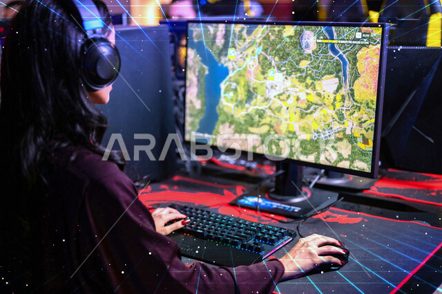 Photography from the back of a Saudi Arabian Gulf woman wearing a headset and playing video games, fun and entertainment with computer games, playing in a video game cafe, techniques and games, entertainment activities
