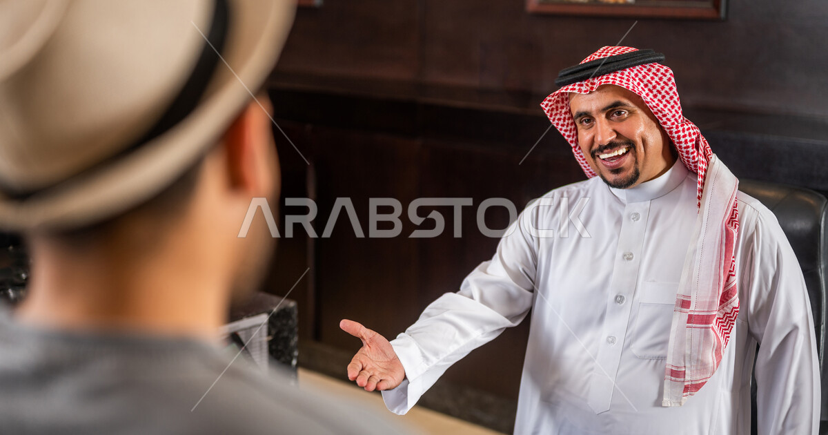 A Saudi Arabian Gulf receptionist who happily receives and welcomes an ...