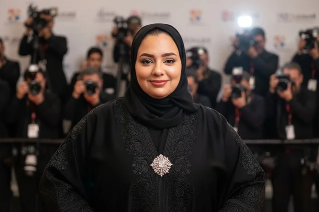 Emirati Woman in Traditional Black Abaya on Red Carpet