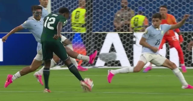 The Saudi national team player shoots the ball in an exciting match on the field, World Cup 2026 matches.