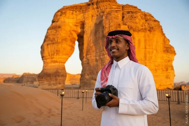 A Saudi photographer at Elephant Mountain in Al-Ula at sunset. A Saudi photographer at Elephant Mountain in Al-Ula at sunset.