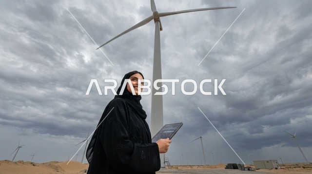 Arab Woman Engineer with Tablet at Wind Farm Turbine