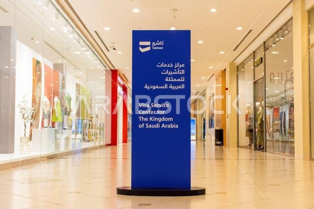 لوحة إرشادية زرقاء لمركز خدمات تأشيرات تشهير للمملكة العربية السعودية في ردهة مبنى مشرقة وحديثة في دبي، الإمارات العربية المتحدة.