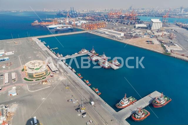 Jeddah, Saudi Arabia - December 22, 2019: Jeddah Islamic Seaport aerial view with moored tugs and pilot boats on a sunny day