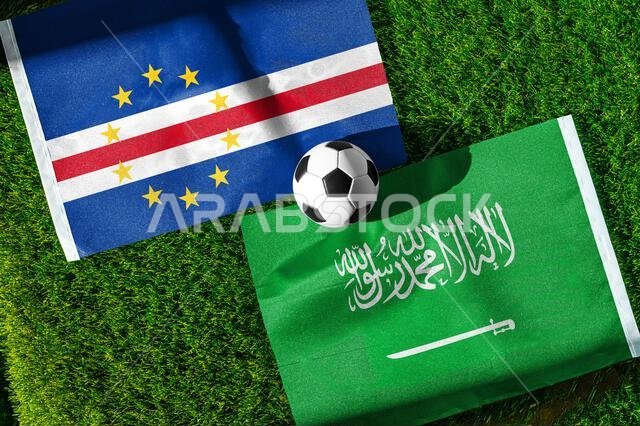 Cape Verde vs Saudi Arabia, national flags before world championship Group H group stage match, football on green pitch with goal in the background, H