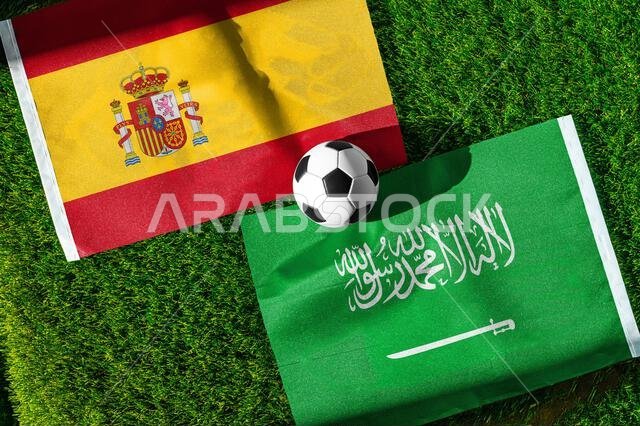 Spain vs Saudi Arabia, national flags before world championship Group H group stage match, football on green pitch with goal in the background, Atlant