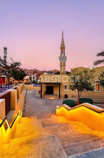 Evening view of a contemporary mosque with a traditional minaret and glowing stairs in the Aljadidah district of AlUla, Saudi Arabia Evening view of a contemporary mosque with a traditional minaret and glowing stairs in the Aljadidah district of AlUla, Saudi Arabia
