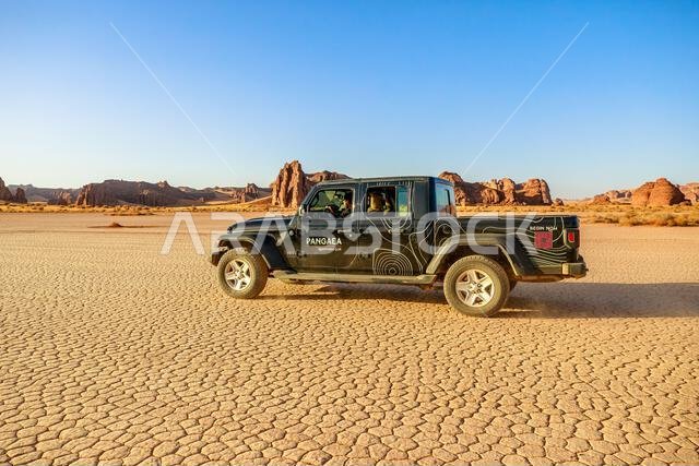AlUla, Saudi Arabia,Jan 5, 2025: 4x4 off-road car navigating dirt road through towering sandstone formations in AlUla Sharaan Nature Reserve, in a