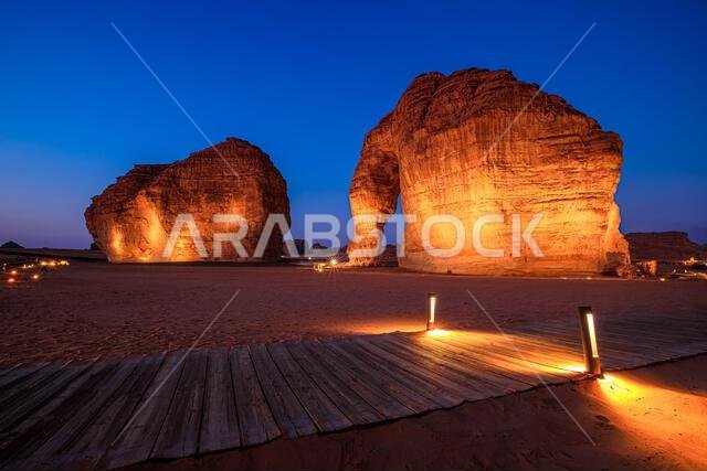 Elephant Rock, a natural sandstone formation known as Jabal AlFil, standing prominently in the desert landscape of AlUla, Saudi Arabia, bathed in warm Elephant Rock, a natural sandstone formation known as Jabal AlFil, standing prominently in the desert landscape of AlUla, Saudi Arabia, bathed in warm