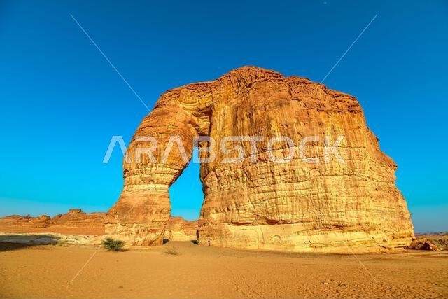 Elephant Rock, also known as Jabal AlFil, dominating the desert landscape in AlUla, Saudi Arabia, creating a stunning natural arch with the sun