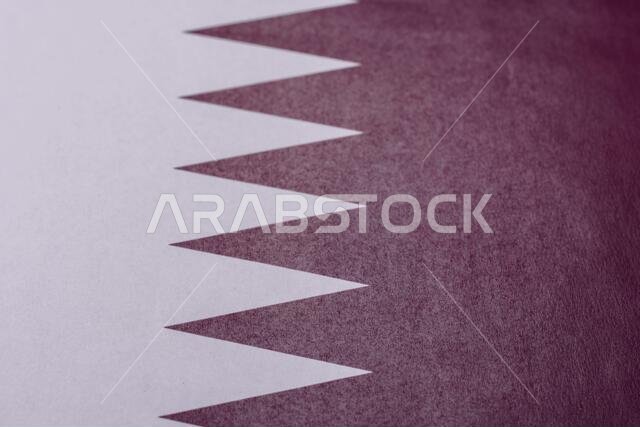 Qatar, the Qatari flag as a symbol of national independence. The Qatari flag as a background for your design.