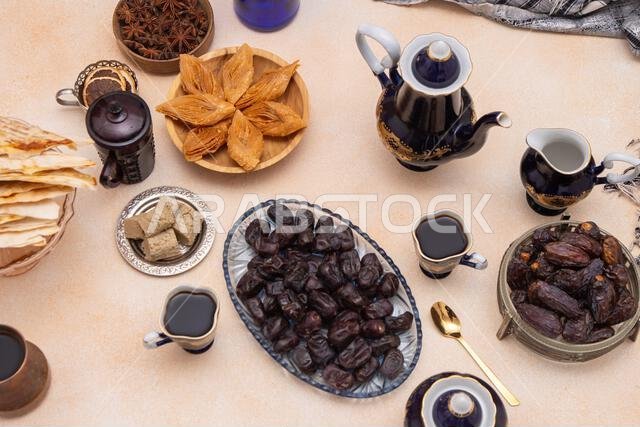 Coffee set with decanter, creamer, and cups. Vintage tableware. Oriental sweets and coffee on the table. Baklava, halva, Dates fruit for dessert. Food and drink at home
