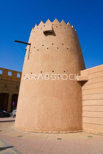 Traditional mud brick watchtower with decorative crenellations in Al Dho historical district, Riyadh, Saudi Arabia