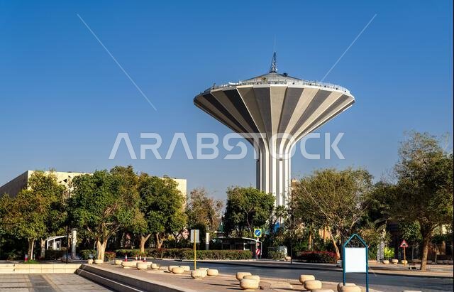Riyadh Water Tower standing tall under a clear blue sky in Al Watan Park, Saudi Arabia, surrounded by green trees. Riyadh Water Tower standing tall under a clear blue sky in Al Watan Park, Saudi Arabia, surrounded by green trees.