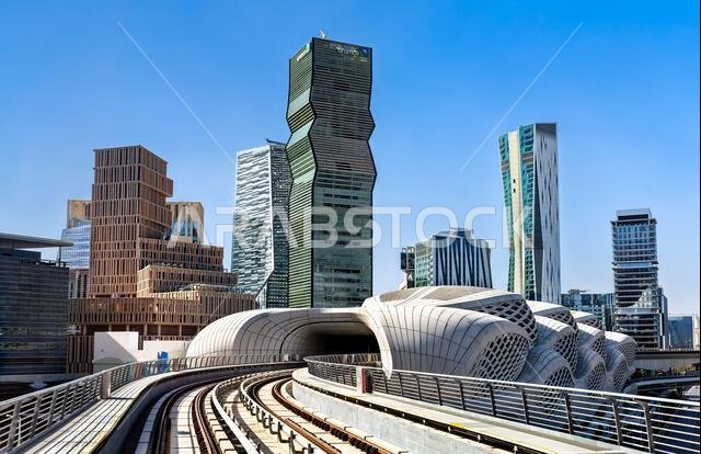 Riyadh, Saudi Arabia - February 20, 2026: Futuristic architecture of KAFD Metro Station with skyscrapers of the King Abdullah Financial District under a clear blue sky