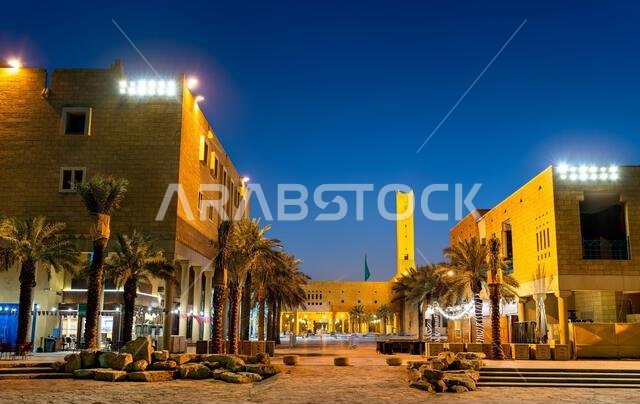 Night view of traditional Saudi architecture and palm trees at Deera Square in the historic Ad Dirah district of Riyadh, Saudi Arabia.