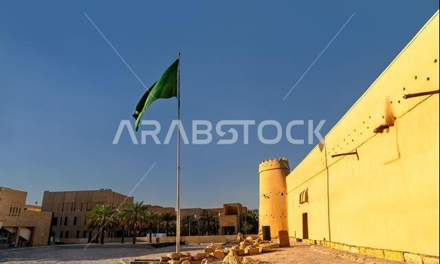 قلعة المصمك التاريخية المبنية من الطين والطوب اللبن تحت سماء زرقاء مع العلم الوطني السعودي يرفرف في الرياض، المملكة العربية السعودية. قلعة المصمك التاريخية المبنية من الطين والطوب اللبن تحت سماء زرقاء مع العلم الوطني السعودي يرفرف في الرياض، المملكة العربية السعودية.