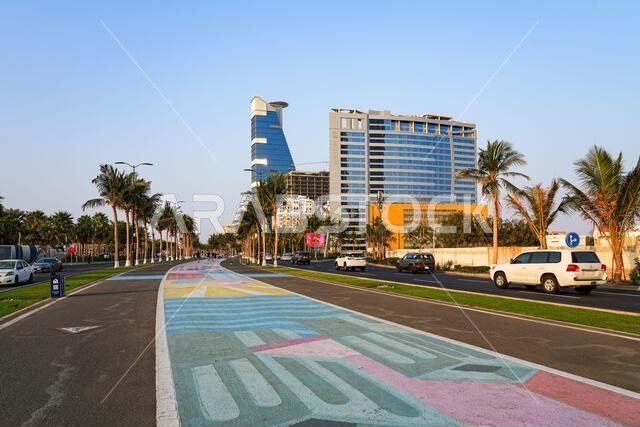 Colorful painted pedestrian walkway and skyscrapers at Jeddah New Corniche waterfront, Saudi Arabia