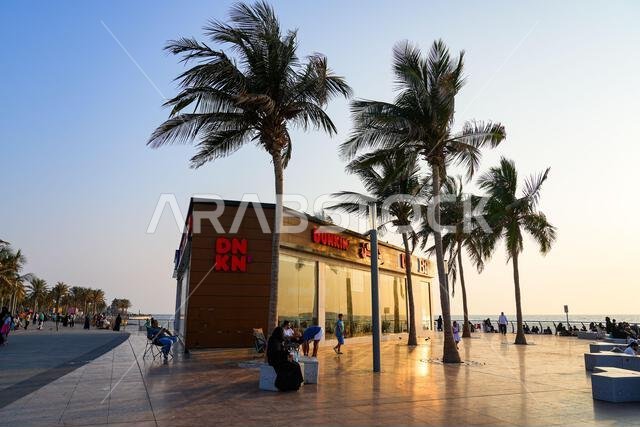 Dunkin coffee shop at sunset on the Jeddah New Corniche waterfront, Saudi Arabia