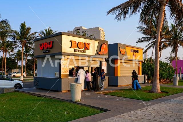 BON Cafe kiosk and palm trees on the waterfront promenade of Jeddah New Corniche, Saudi Arabia