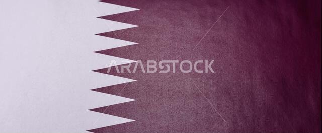 قطر، والعلم القطري رمزاً للاستقلال الوطني. العلم القطري كخلفية لتصميمك.