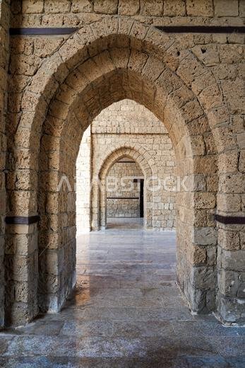 Perspective through the stone arches inside the historic Bab Makkah gate in Jeddah, Saudi Arabia