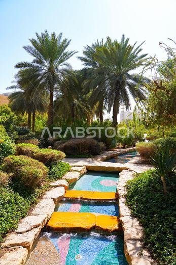 Water stream cascade and palm trees in the gardens of the National Museum of Saudi Arabia in Riyadh
