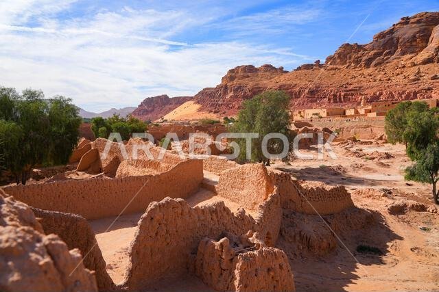 Traditional mudbrick wall path weaving through the lush green palm oasis in AlUla, Saudi Arabia