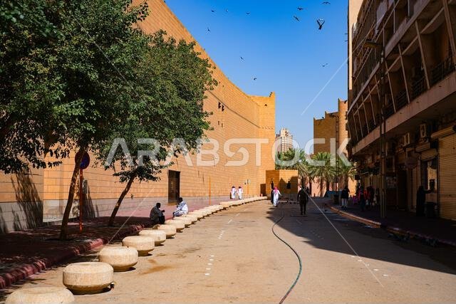 High limestone fortified wall of the Imam Turki bin Abdullah Grand Mosque along a street in Riyadh, Saudi Arabia