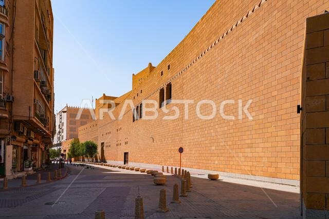 High limestone fortified wall of the Imam Turki bin Abdullah Grand Mosque along a street in Riyadh, Saudi Arabia
