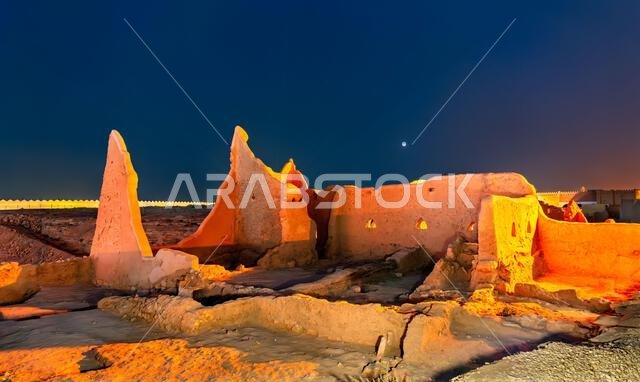 The illuminated mud brick ruins of At-Turaif World Heritage Site in historic Diriyah, Saudi Arabia, captured under a twilight sky. The illuminated mud brick ruins of At-Turaif World Heritage Site in historic Diriyah, Saudi Arabia, captured under a twilight sky.