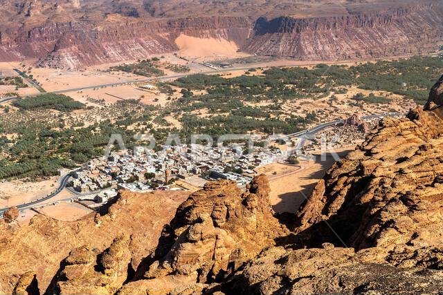 A high angle perspective of the Al Ula oasis and surrounding mountains from the Harrat Viewpoint in Saudi Arabia.