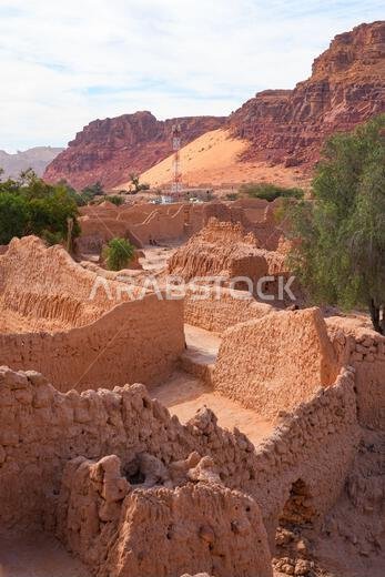 Ancient mudbrick ruins and lush green trees in the historical heritage oasis of AlUla, Saudi Arabia