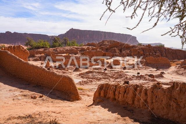Ancient mudbrick ruins and lush green trees in the historical heritage oasis of AlUla, Saudi Arabia