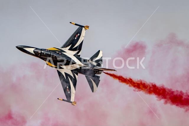 Riyadh, Saudi Arabia - 10 2 2026: fighter jet emitting red smoke