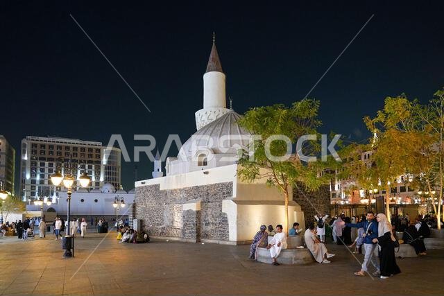 Night view of the historic Abu Bakr As-Siddiq Mosque and bustling plaza in Madinah, Saudi Arabia